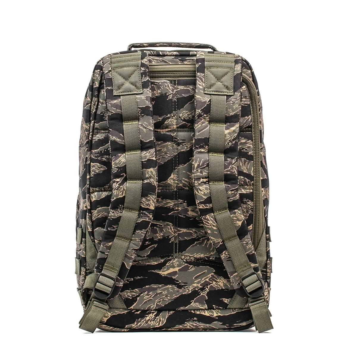 The GR1 - USA - Tiger Stripe is a camouflage-patterned backpack, shown from the back, featuring padded shoulder straps and buckles.
