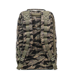 The GR1 - USA - Tiger Stripe is a camouflage-patterned backpack, shown from the back, featuring padded shoulder straps and buckles.