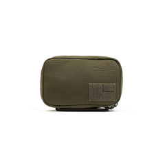 The GR1 Field Pocket by GORUCK is a compact, rectangular olive green pouch with a zipper closure, perfect for organizing electronics. It includes a velcro patch on the front for customization and offers a simple, utilitarian design ideal for sorting small items or tools.