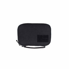 The GR1 Field Pocket by GORUCK is a compact black fabric pouch equipped with a zipper and a side wrist strap. Designed as an ideal electronics organizer, it features a rectangular velcro patch on the front for enhanced convenience.