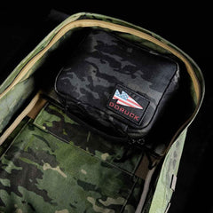GORUCK rucking backpack with camouflage interior and black GORUCK pouch featuring USA flag patch