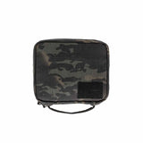 GORUCK camouflage pouch with black Velcro patch panel and top handle on white background