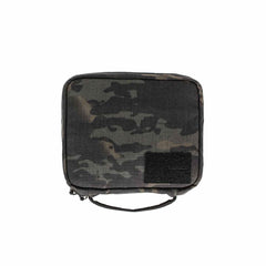 GORUCK camouflage pouch with black Velcro patch panel and top handle on white background