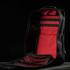 Open GR1 USA x Carryology - GRXC2 Samurai backpack in black with a red interior, showing mesh and textured compartments made from premium Japanese cotton, set against a black background.