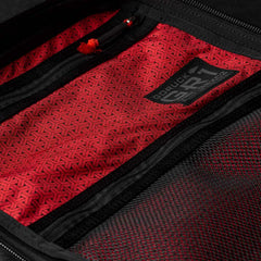 Close-up of an open backpack pocket lined with red patterned Japanese cotton fabric, featuring the GR1 USA x Carryology - GRXC2 Samurai label.