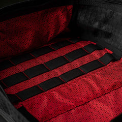 Close-up of the GR1 USA x Carryology - GRXC2 Samurai bag’s red patterned Japanese cotton interior and black mesh straps forming horizontal loops.