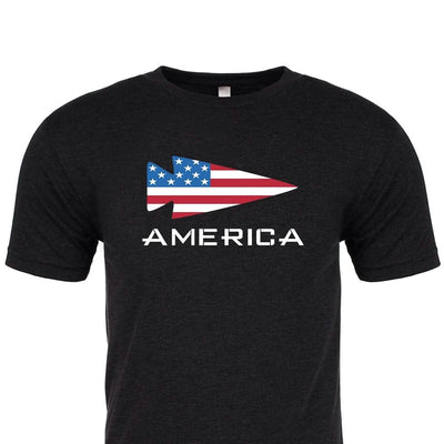 The America Tee - Tri-Blend by vendor-unknown features a premium tri-blend black material adorned with an arrowhead design filled with the American flag pattern. The word "AMERICA" is boldly printed in white letters below the arrowhead. Proudly made and printed in the USA.