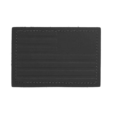 Introducing the "Patch - Leather Reverse Flag" by vendor-unknown: a genuine leather patch featuring an embossed American flag design with stars and stripes, complemented by a stitched border and durable VELCRO® backing.
