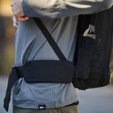GORUCK padded hip belt on backpack, worn by person in gray shirt outdoors
