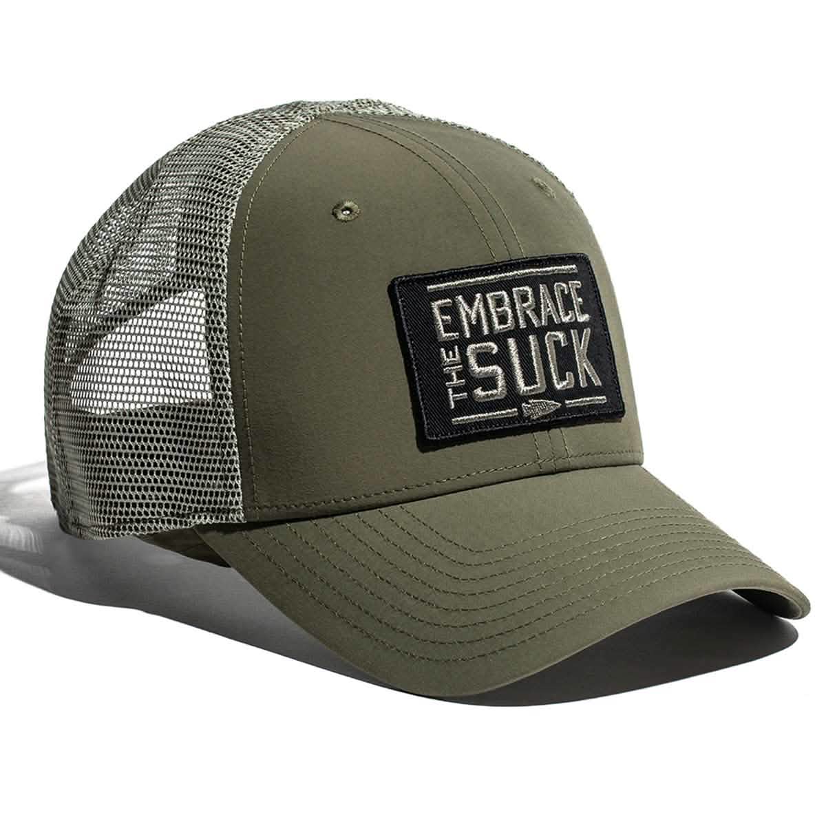 The Performance Trucker Hat - Embrace the Suck by GORUCK comes in olive green and includes a mesh back with a front patch featuring the slogan 