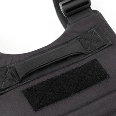 Close-up of the Training Weight Vest - Black, showcasing its sturdy handle and rectangular Velcro patch, with an adjustable fit for workouts.